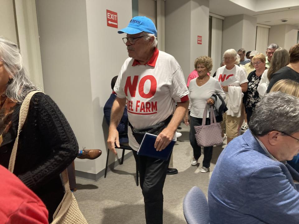 People leave the Volusia County Council chambers on Tuesday night after the council voted in support of a moratorium on development at 874 Hull Road and other properties zoned as heavy industrial. Some people wore T-shirts in opposition to a proposed fuel farm.