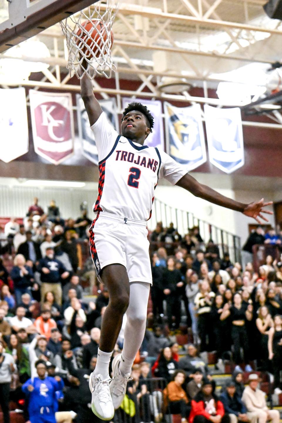 East Lansing's KJ Torbert dunks after a steal against Portage Central during the second quarter on Thursday, March 7, 2024, at Kalamazoo Central High School.