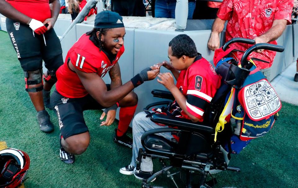 N.C. State’s Juice Vereen (11) greet Grayson Ketchie after the Wolfpack’s 48-41 victory over Marshall at Carter-Finley Stadium in Raleigh, N.C., Saturday, Oct. 7, 2023.