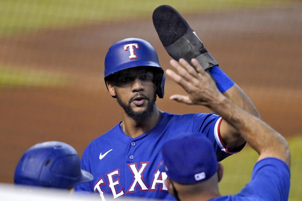 Texas Rangers' Leody Taveras celebrates after scoring on a ground out hit by teammate Isiah Kiner-Falefa during the first inning of a baseball game against the Arizona Diamondbacks, Wednesday, Sept. 23, 2020, in Phoenix. (AP Photo/Matt York)