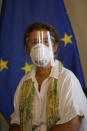 European Union Ambassador to Venezuela Isabel Brilhante Pedrosa wears a mask and face shield amid the COVID-19 pandemic, as she meets with Venezuelan Foreign Minister Jorge Arreaza at his office in Caracas, Venezuela, Wednesday, Feb. 24, 2021. The meeting was called after the EU sanctioned an additional 19 Venezuelans for "undermining democracy and the rule of law" in Venezuela and the National Assembly declared the EU ambassador "persona non grata." (AP Photo/Ariana Cubillos)