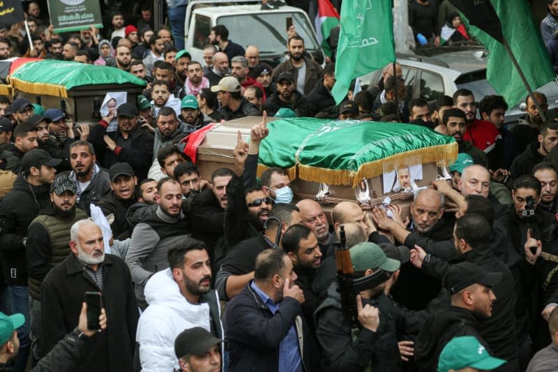 Mourners carry the coffins of Hamas officials Saleh al Arouri, Azzam al-Akraa and Mohamad al-Rays during their funeral procession. Arouri, Akraa and Rays as well as four other Hamas officials were allegedly killed by Israel on Tuesday evening in the southern suburbs of the Lebanese capital Beirut. Marwan Naamani/dpa