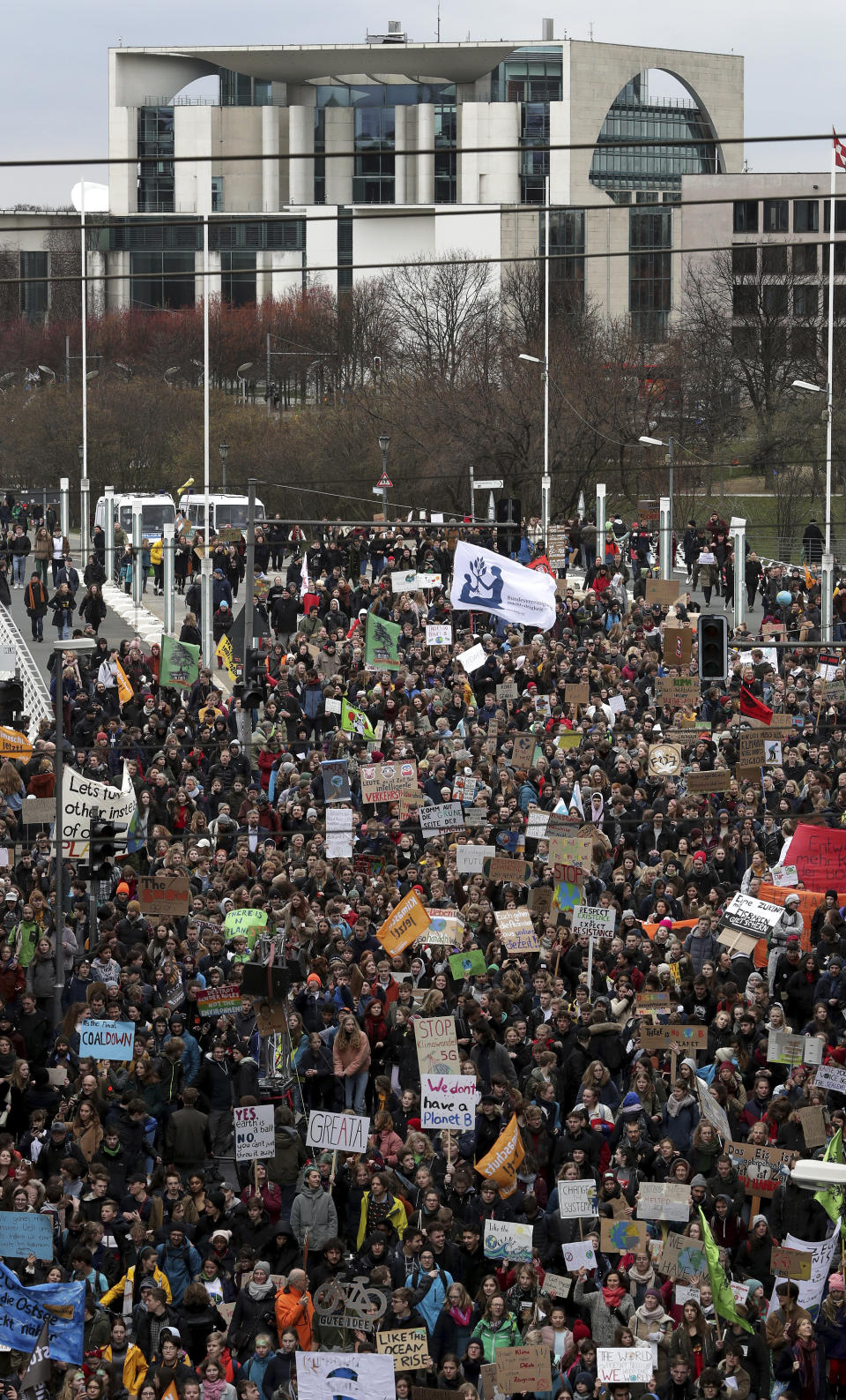 Students attend a protest ralley of the 'Friday For Future Movement' in Berlin, Germany, Friday, March 15, 2019. The building in the background is the Chancelery (AP Photo/Michael Sohn)