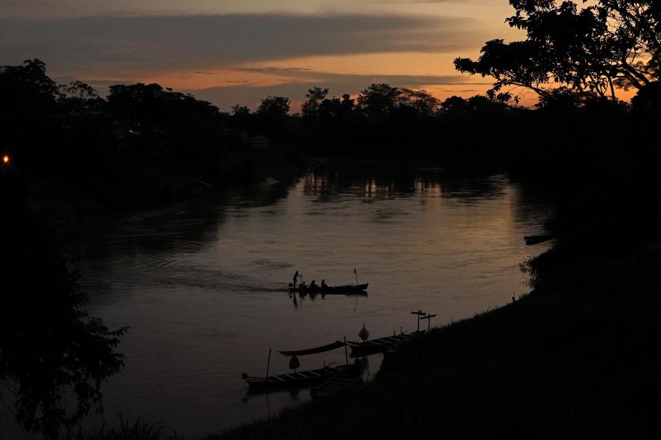 A small passenger boat crosses the Acre River between the city and the access road to the Chico Mendes Extractive Reserve, in Xapuri, Acre state, Brazil, Wednesday, Dec. 7, 2022. Brazil's incoming president has promised to eliminate all deforestation by 2030, which would be a complete change of course for Brazil compared to the last four years. (AP Photo/Eraldo Peres)