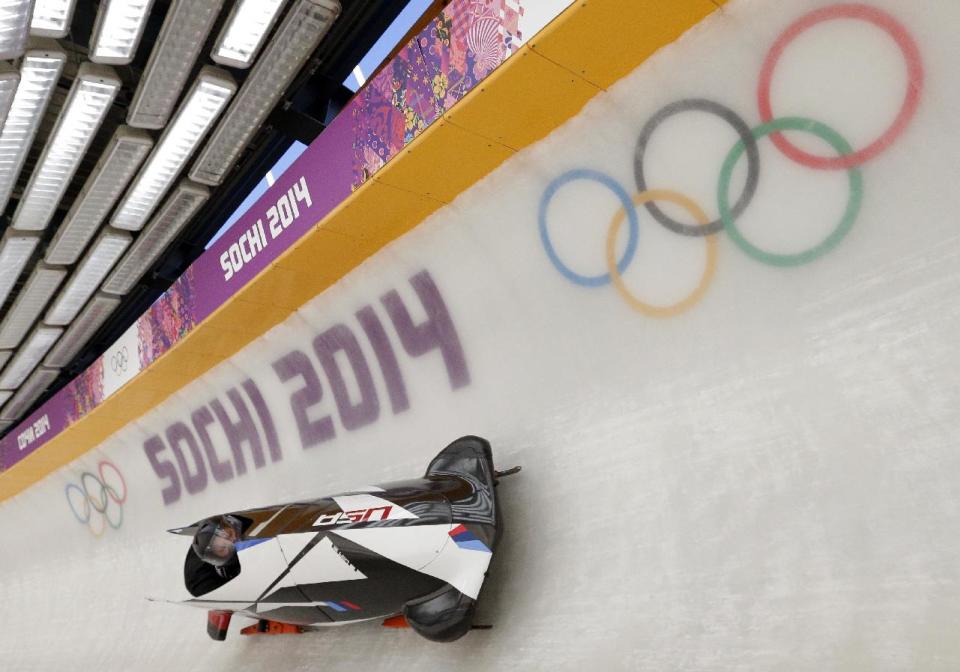 The USA-1 sled from the United States piloted by Steven Holcomb, takes a turn during a training run for the two-man bobsled at the 2014 Winter Olympics, Thursday, Feb. 6, 2014, in Krasnaya Polyana, Russia. (AP Photo/Michael Sohn)