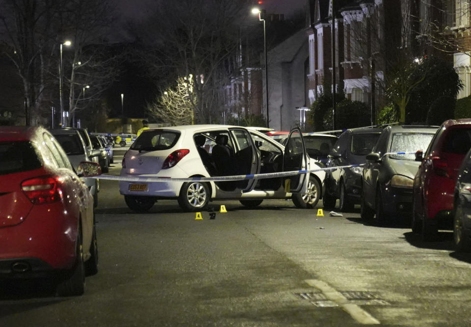 The scene is cordoned off in Lessar Avenue near Clapham Common, south London, where a woman and her two young children have been taken to hospital after a man threw a suspected corrosive substance, Thursday, Feb. 1, 2024. British police said Wednesday they are hunting for a suspect after several people were injured with a corrosive substance in London. (James Weech/PA via AP)