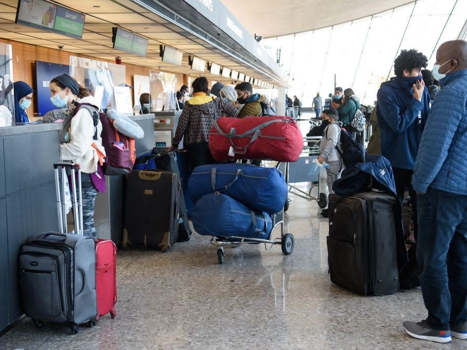 Travellers check in at Washington's Dulles International Airport in Dulles, Virginia, on November 24, 2020. - Thanksgiving travel is expected to be down by around 50 percent this year due to the new coronavirus pandemic.Stopping short of issuing an outright ban, the US government's health protection agency has for the first time called on Americans not to travel for the annual holiday, which sees families get together over turkey, yams and cranberry sauce and for many is more important than Christmas. (Photo by NICHOLAS KAMM / AFP) (Photo by NICHOLAS KAMM/AFP via Getty Images)