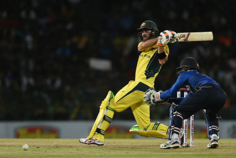 Australia's Glenn Maxwell hits a shot as Sri Lankan's Kusal Perera (R) looks on during the final T20 match at in Colombo on September 9, 2016