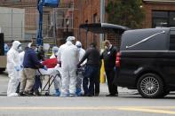 Workers load deceased person into a waiting hearse outside Brooklyn Hospital Center during the coronavirus disease (COVID-19) in New York