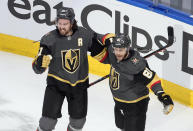 Vegas Golden Knights' Mark Stone (61) and Jonathan Marchessault (81) celebrate a goal against the Chicago Blackhawks during the second period of a first-round NHL Stanley Cup playoff hockey series in Edmonton, Alberta, Thursday, Aug. 13, 2020. (Jason Franson/The Canadian Press via AP