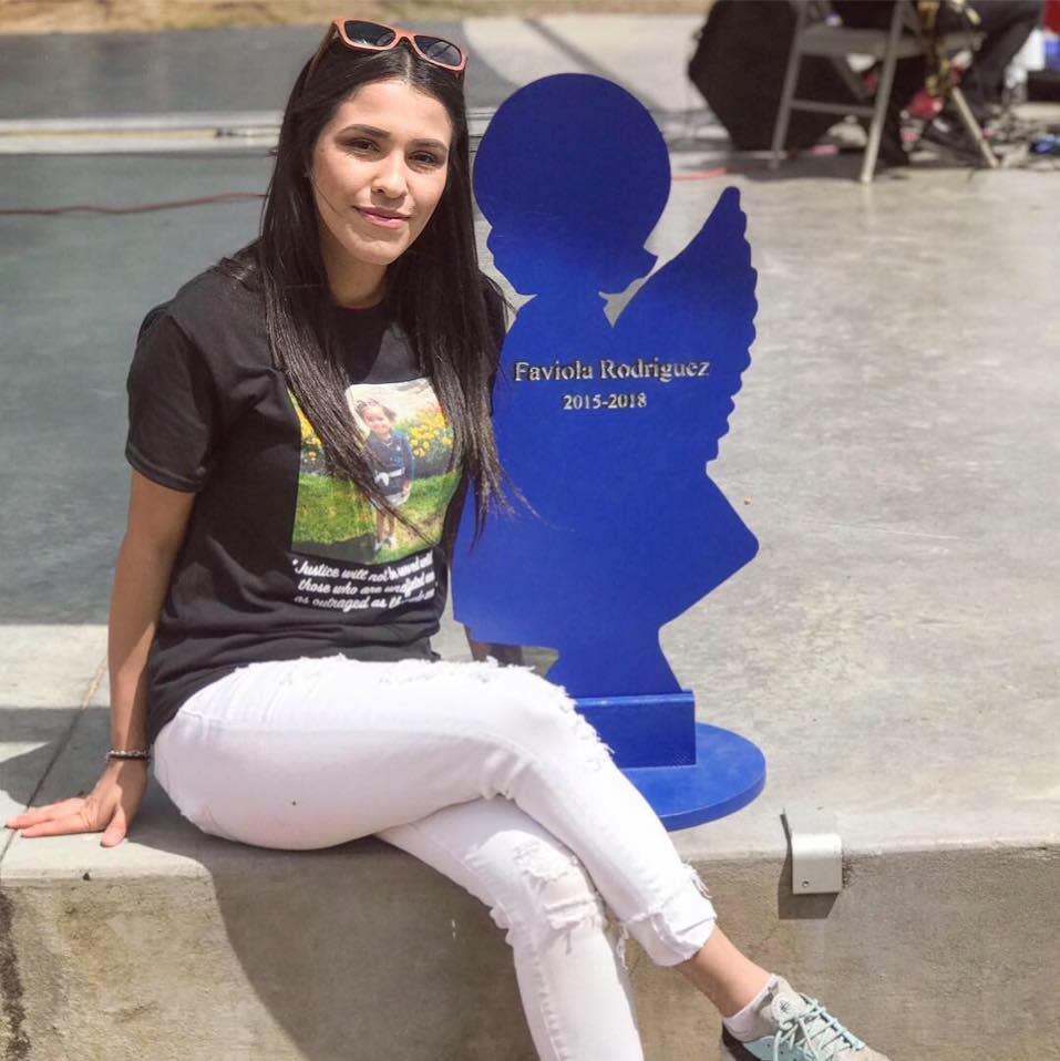 Saundra Gonzales poses with the blue angel representing her daughter, Faviola Nova Rodriguez. Gonzales' boyfriend at the time, Lalo Anthony Castrillo, is charged with causing Faviola's death.