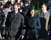 Britain's Prince William, left, accompanied by his wife Kate, Duchess of Cambridge, arrive to attend a Christmas Day Service with other members of the royal family at St. Mary's church on the grounds of Sandringham Estate, the Queen's retreat, in Norfolk, England, Wednesday, Dec. 25, 2013. (AP Photo/Lefteris Pitarakis)