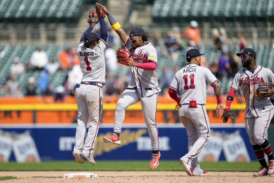 Atlanta Braves' Ozzie Albies (1) and Ronald Acuna Jr., second from left, celebrate with Orlando Arcia (11) and Raisel Iglesias after the final out against the Detroit Tigers in the ninth inning during the first baseball game of a doubleheader, Wednesday, June 14, 2023, in Detroit. (AP Photo/Paul Sancya)