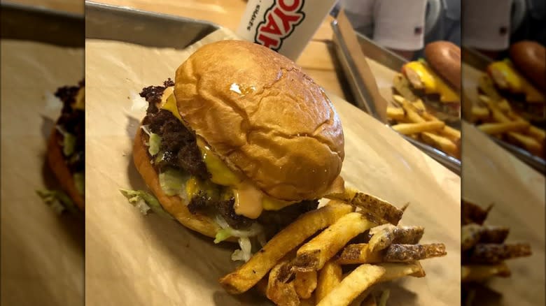 mooyah burger with fries and cup