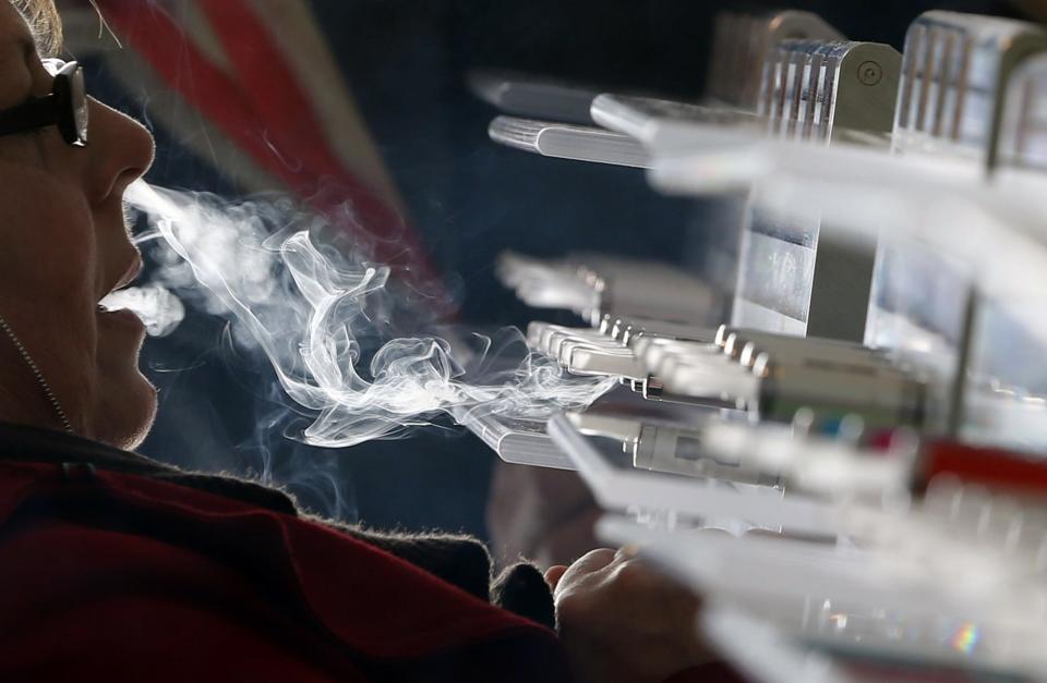 A customer tests e-liquids for e-cigarettes during the first international fair of electronic cigarette and vapology "Vapexpo" in Bordeaux, southwestern France, March 13, 2014. REUTERS/Regis Duvignau (FRANCE - Tags: BUSINESS HEALTH SOCIETY)