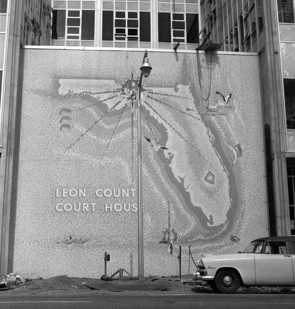 Covered tile mosaic map of Florida behind the Leon County Courthouse at 301 S. Monroe St. in Tallahassee. This map of Florida, set in tile at the rear of the County Courthouse addition, caused a lot of talk in Tallahassee. The map cost about $5,000. Some people have been critical of the spelling of the word Courthouse as Court House. Others say it's a bad location. Notice that a light pole is directly in front of it.