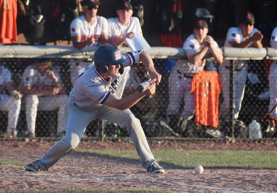 Ballard's Bryce Haessig bunts the ball against Ames during the fourth inning of the Bombers' 7-5 victory Tuesday, June 21, 2022, in Ames, Iowa.