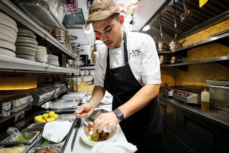 Chef Davide Sanna works in the kitchen of Piccola Cucina in the SoHo area of New York