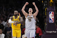 Denver Nuggets center Nikola Jokic (15) celebrates after Los Angeles Lakers forward LeBron James, left, missed a layup attempt as time expired in the second half of Game 4 of the NBA basketball Western Conference Final series Monday, May 22, 2023, in Los Angeles. Denver won 113-111 to win the series. (AP Photo/Ashley Landis)