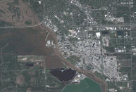 This photo provided by Maxar Technologies shows an overview of Midland, Mich., Thursday, May 21, 2020, with floodwaters along the Tittabawassee River. (Maxar Technologies via AP)