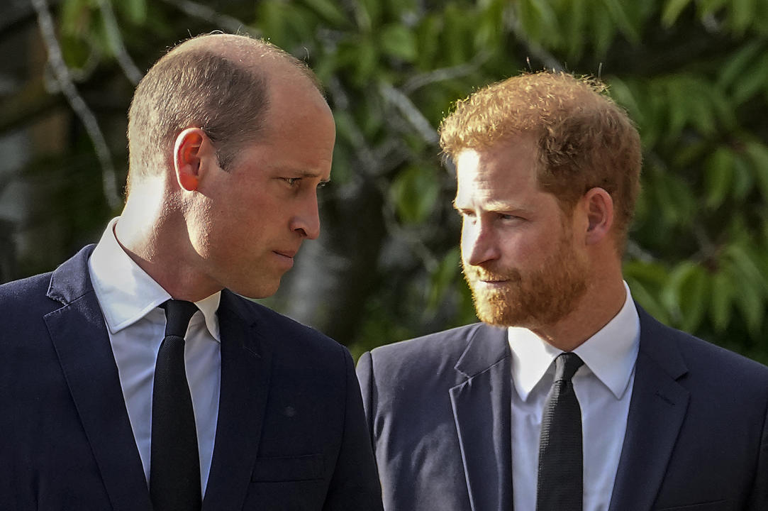 FILE - Britain's Prince William and Britain's Prince Harry walk beside each other after viewing the floral tributes for the late Queen Elizabeth II outside Windsor Castle, in Windsor, England on Sept. 10, 2022. Prince Harry flew more than 5,000 miles to see his father after King Charles III was diagnosed with cancer. But he did not see his estranged brother, William, during a visit that lasted scarcely 24 hours. William, meanwhile, returned to public duties for the first time since his wife, Kate, was admitted to a London hospital Jan. 16 for abdominal surgery. (AP Photo/Martin Meissner, File)