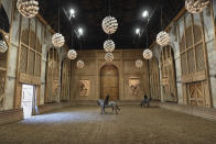 A horsewoman practices with her horse in the stables' riding arena of the royal stables, in Versailles, Thursday, April 25, 2024. More than 340 years after the royal stables were built under the reign of France's Sun King, riders and horses continue to train and perform in front of the Versailles Palace. The site will soon keep on with the tradition by hosting the equestrian sports during the Paris Olympics. Commissioned by King Louis XIV, the stables have been built from 1679 to 1682 opposite to the palace's main entrance. (AP Photo/Aurelien Morissard)