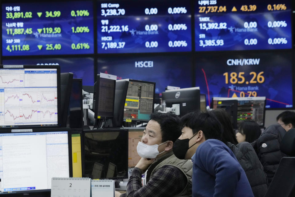 Currency traders watch monitors at the foreign exchange dealing room of the KEB Hana Bank headquarters in Seoul, South Korea, Tuesday, Feb. 7, 2023. Asian stock markets rebounded Tuesday after Wall Street sank under pressure from worries about higher interest rates and after Japan reported stronger wage gains than expected. (AP Photo/Ahn Young-joon)