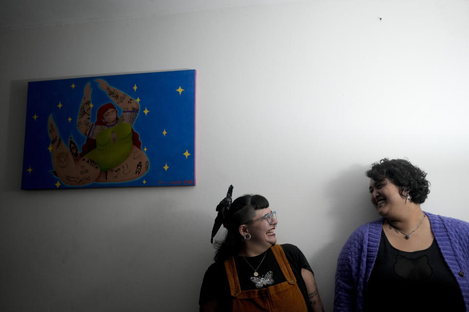 Ana Ottobre, right, and Aldana Mendez, smile at each other in Villa Carlos Paz, Argentina, Wednesday, July 19, 2023. Both women feel tarot guides their life, as they identify as spiritual but not religious. In the pope’s homeland of Argentina, Catholics have been renouncing the faith and joining the growing ranks of the religiously unaffiliated. Commonly known as the “nones,” they describe themselves as atheists, agnostics, spiritual but not religious, or simply: “nothing in particular.” (AP Photo/Natacha Pisarenko)