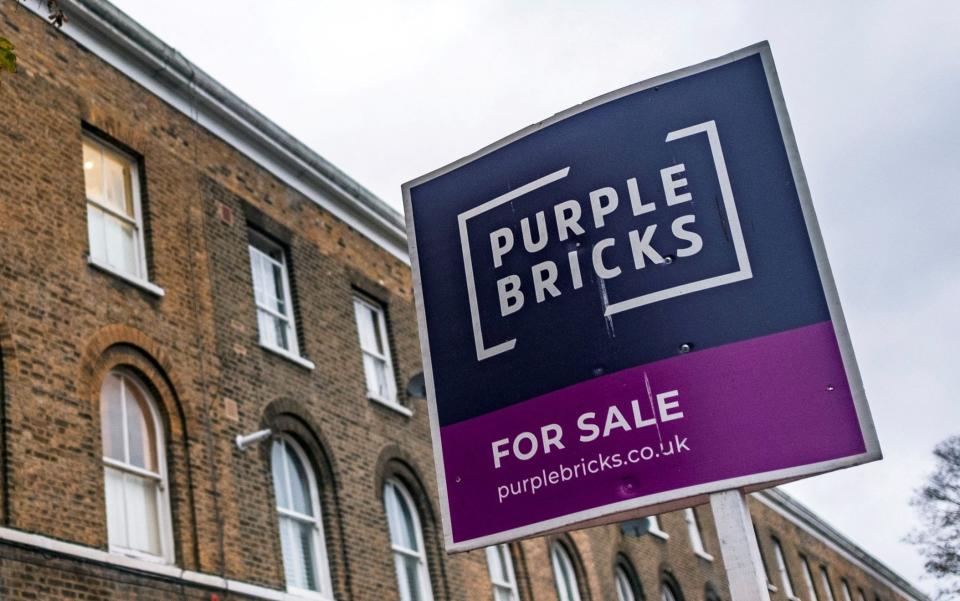 A sign for online estate agent Purplebricks is pictured outside a property in a residential street in London, Britain, November 24, 2021 - MAY JAMES/REUTERS