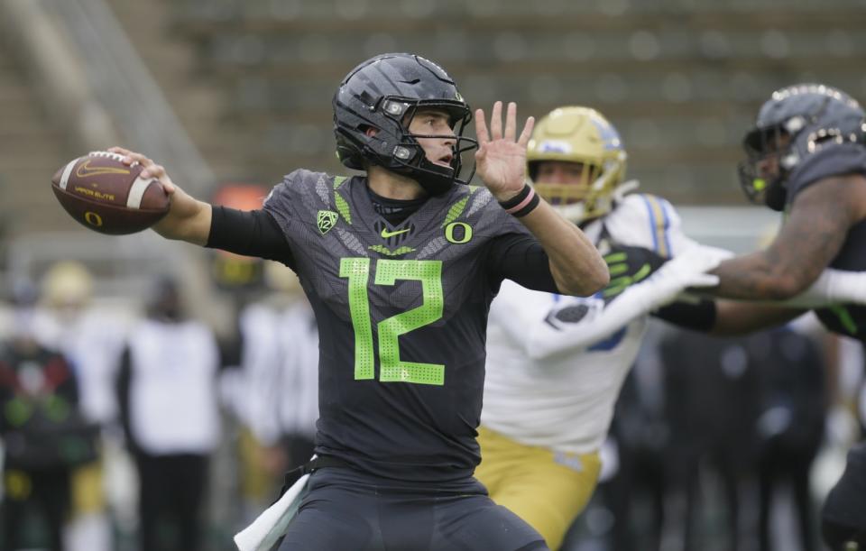 Oregon's Tyler Shough throws downfield against UCLA during the third quarter Nov. 21, 2020.