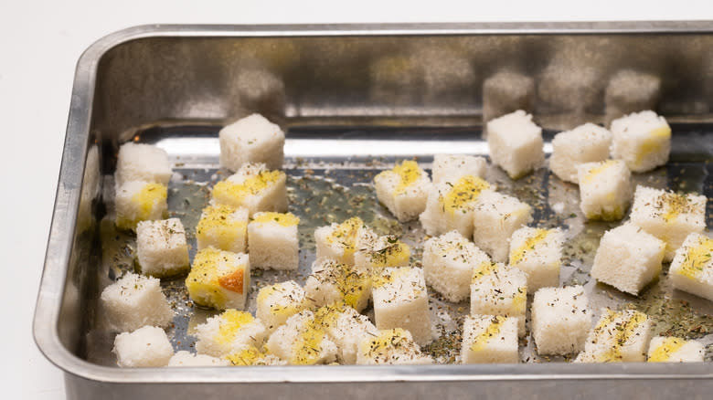 cubed bread in oven tray