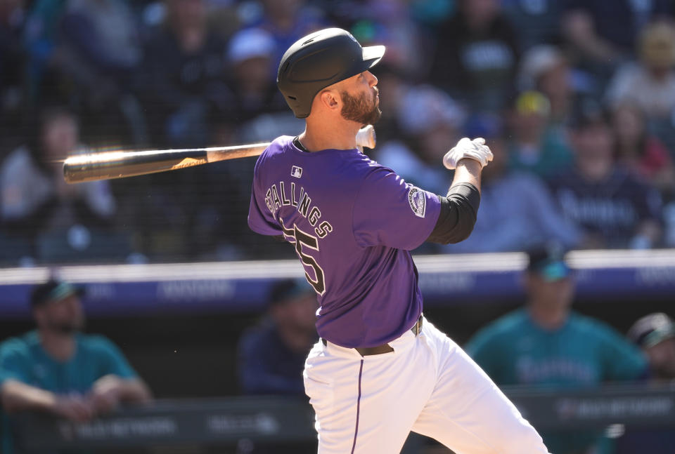 Colorado Rockies' Jacob Stallings follows the flight of his fly ball off Seattle Mariners relief pitcher Ryne Stanek in the ninth inning of the first game of a baseball doubleheader Sunday, April 21, 2024, in Denver. A fan interfered with Mariners left fielder Dylan Moore when he tried to catch the ball at the wall which resulted in a review of the play. Stallings was declared out due to the interference. (AP Photo/David Zalubowski)