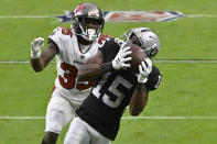 Las Vegas Raiders wide receiver Nelson Agholor (15) catches a pass over Tampa Bay Buccaneers cornerback Jamel Dean (35) during the second half of an NFL football game, Sunday, Oct. 25, 2020, in Las Vegas. (AP Photo/David Becker)