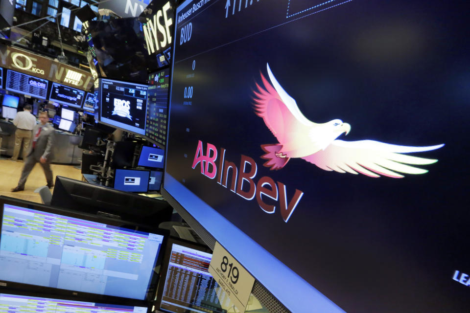FILE - The symbol for ABInBev appears at the post where it trades, on the floor of the New York Stock Exchange, Tuesday, Oct. 13, 2015. The International Olympic Committee has signed Anheuser-Busch InBev as the first beer brand in the 40-year history of its sponsorship program, which earns billions of dollars for the organization and international sports. (AP Photo/Richard Drew, File)