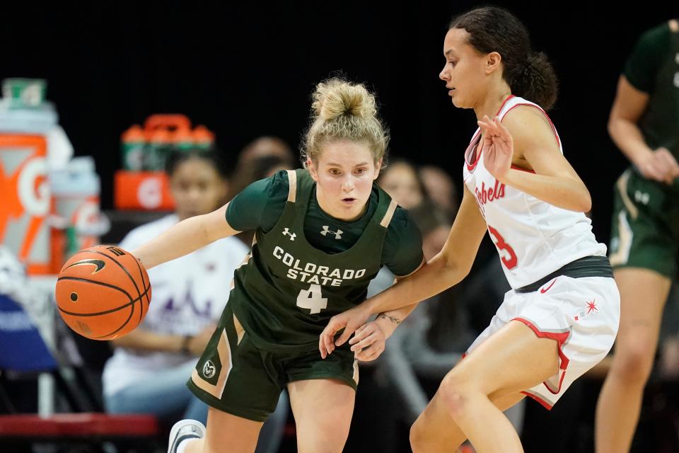 Colorado State guard McKenna Hofschild (4) drives as UNLV guard Kiara Jackson (3) defends during the first half of an NCAA college basketball game for the championship of the Mountain West Conference women's tournament Wednesday, March 9, 2022, in Las Vegas. (AP Photo/Rick Bowmer)