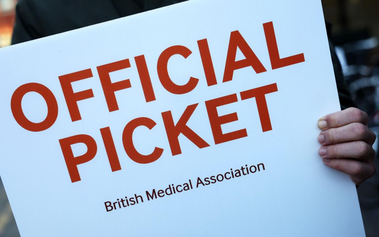 A placard is pictured at a junior doctors' picket outside the Royal London Hospital in London