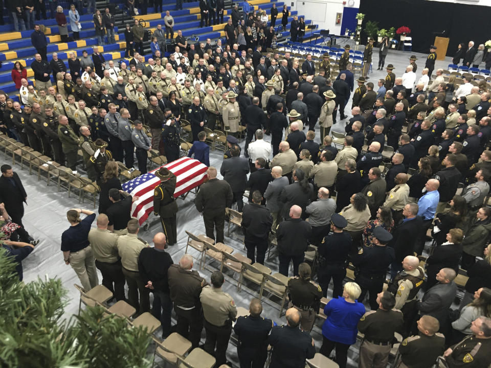 Many law enforcement agencies including those in the Bismarck-Mandan area sent representatives to the funeral of Mercer County Deputy Paul Martin to pay respects to a fallen comrade, Wednesday, Dec. 13, 2023, in Beulah, N.D. The North Dakota sheriff's deputy was killed last week in a crash involving U.S. Sen. Kevin Cramer's adult son, who was fleeing police during a mental health crisis. Deputy Martin, 53, was a married father of three and an 18-year veteran of the Mercer County Sheriff’s Office. (Brad Nygaard/The Bismarck Tribune via AP)