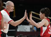 Japan's head coach Thomas Wayne Hovasse, left, high five with Japan's Saori Miyazaki (32) during women's basketball preliminary round game against the United States of America at the 2020 Summer Olympics, Friday, July 30, 2021, in Saitama, Japan. (AP Photo/Eric Gay)