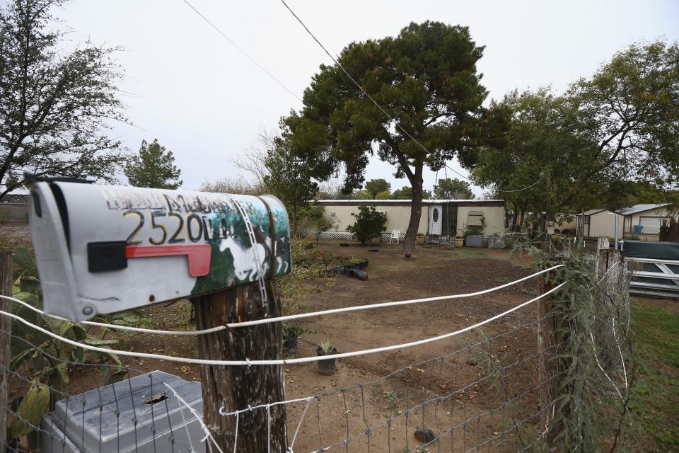 A Phoenix woman has been arrested on suspicion of killing her three children after they were found dead inside the family home at this location Tuesday, Jan. 21, 2020, in Phoenix. (AP Photo/Ross D. Franklin)