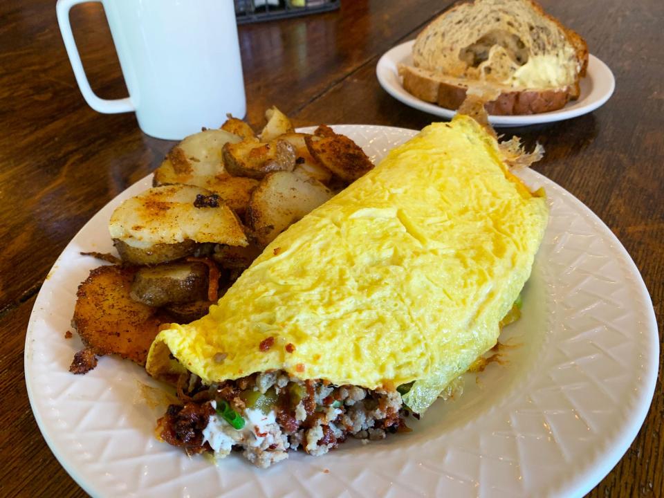 An omelet with bacon, sausage and green chile at The Farmhouse.