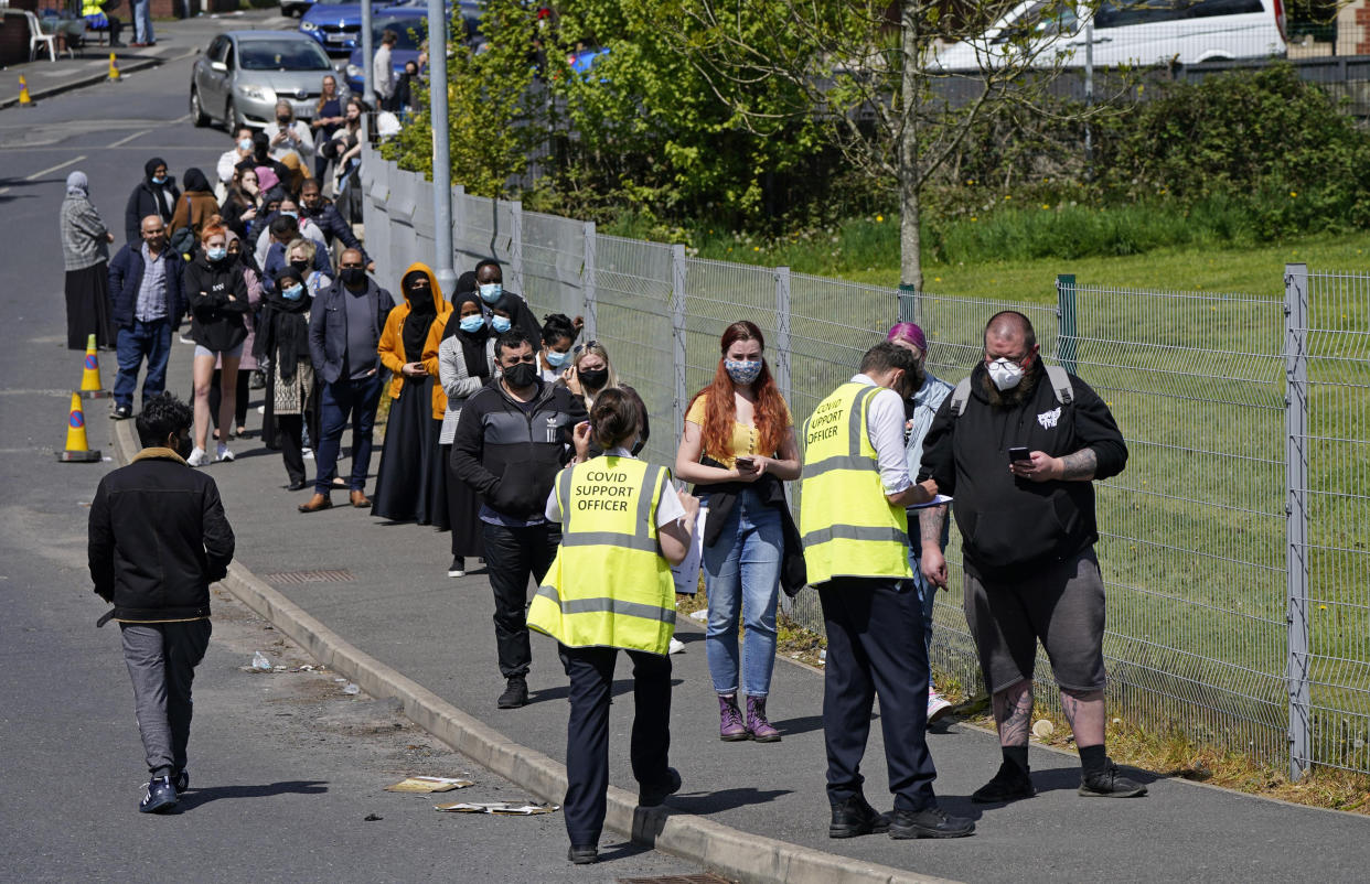 People queuing for Covid vaccinations at the ESSA academy in Bolton as the spread of the Indian coronavirus variant could lead to the return of local lockdowns, ministers have acknowledged. Bolton, Blackburn with Darwen and Bedford are the areas ministers are most concerned about. Picture date: Tuesday May 18, 2021.