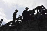 Rescue workers clear the rubble of destroyed houses after a Russian drone attack of a residential neighbourhood, in Zaporizhzhia, Ukraine, on Thursday, March 28, 2024. (AP Photo/Andriy Andriyenko)