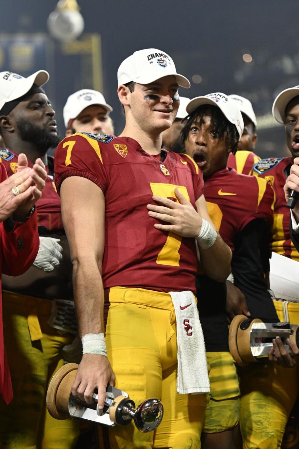 USC quarterback Miller Moss holds the offensive player of the game trophy after the team's win in the Holiday Bowl.