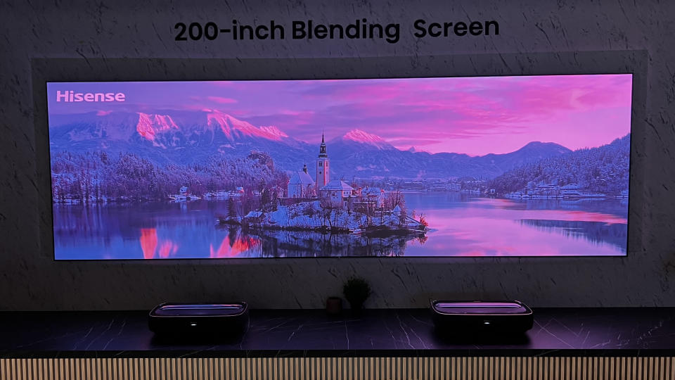 A wide projected screen, with two Hisense Laser TV projectors underneath it