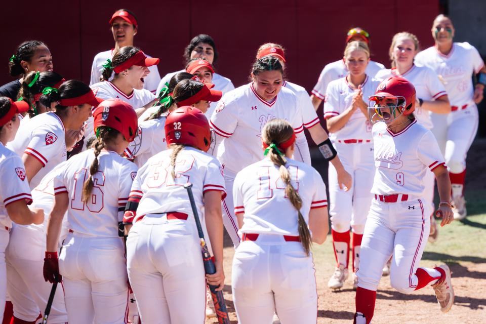 Utah gathers at home plate after a home run by Utah infielder Sophie Jacquez (9) during an NCAA softball game between Utah and UCLA at Dumke Family Softball Stadium in Salt Lake City on April 29, 2023. | Ryan Sun, Deseret News