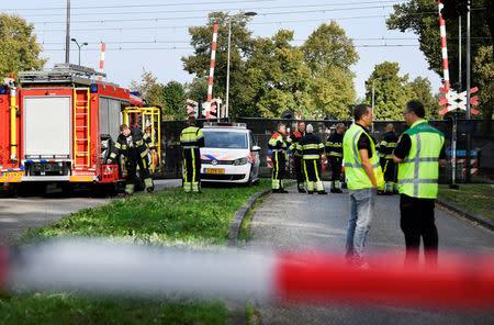 Rescue personnel work at the scene where a train struck a "cargo bicycle", popular with Dutch parents for transporting their children, at the city of Oss, Netherlands, September 20, 2018. REUTERS/Piroschka van de Wouw