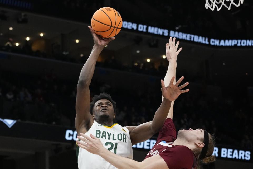 Baylor center Yves Missi shoots savor Colgate forward Keegan Records