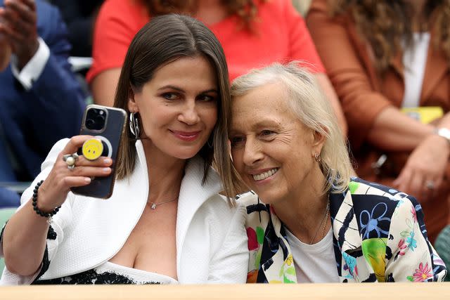 <p>Clive Brunskill/Getty</p> Julia Lemigova and Martina Navratilova.