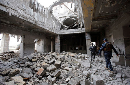 Iraqi Federal Police walk inside Mosul train station in the city of Mosul. REUTERS/Youssef Boudlal