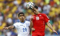 Switzerland's Admir Mehmedi (R) fights for the ball with Jorge Claros of Honduras during their 2014 World Cup Group E soccer match at the Amazonia arena in Manaus June 25, 2014. REUTERS/Dominic Ebenbichler (BRAZIL - Tags: SOCCER SPORT WORLD CUP)